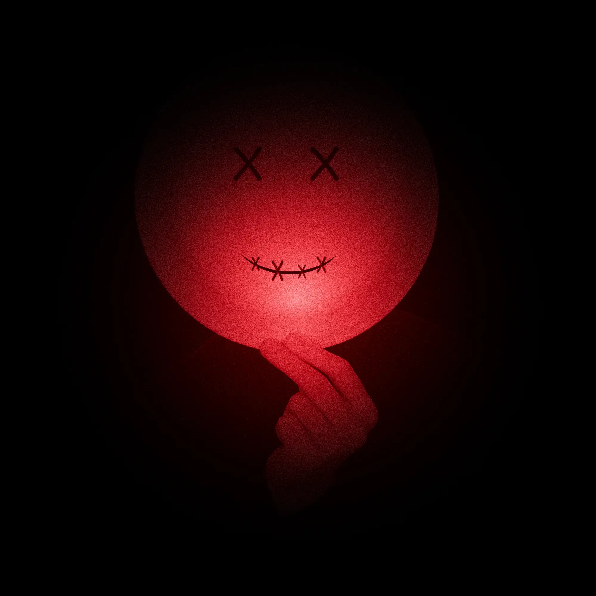 Picture of Jan, hiding his face behind a paper plate with a smiley on it.